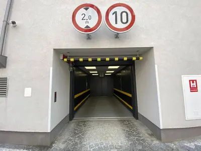a hallway of a building with a door and signs at Seven days Smíchov in Prague