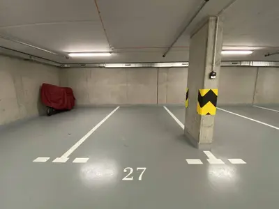 an empty parking garage with a sign on a pole at Seven days Smíchov in Prague