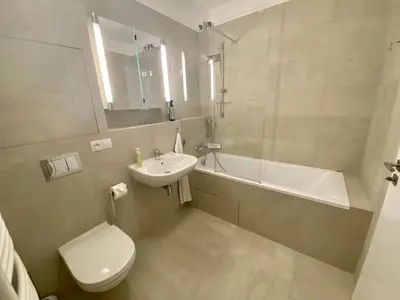 a bathroom with a sink and a toilet and a tub at Seven days Smíchov in Prague