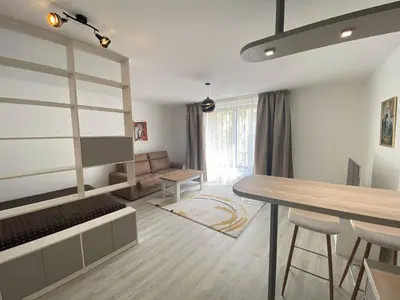 a living room with a table and a couch at Seven days Smíchov in Prague