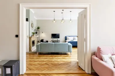 a living room with a blue couch and a living room at Cubistic Residence Eliska / Jewish Quarter / Old Town in Prague