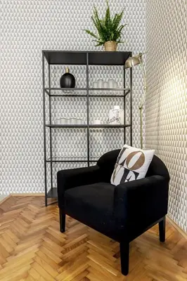 a black chair in a living room with a lamp at Cubistic Residence Eliska / Jewish Quarter / Old Town in Prague