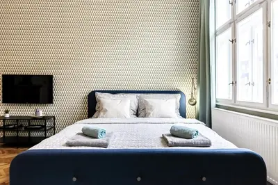 a bedroom with a bed with two pillows on it at Cubistic Residence Eliska / Jewish Quarter / Old Town in Prague