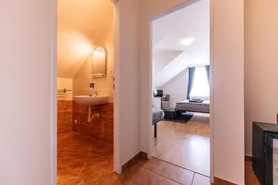 a bathroom with a sink and a mirror at Penzion Stříbrná Lhota in Mníšek pod Brdy