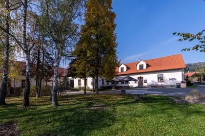 a white building with an orange roof at Penzion Stříbrná Lhota in Mníšek pod Brdy