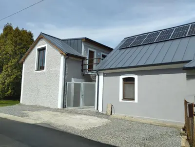 a house with solar panels on the roof at Apartmány Svatá in Svatá