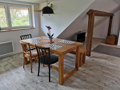 a dining room table and chairs in a room at Apartmány Svatá in Svatá