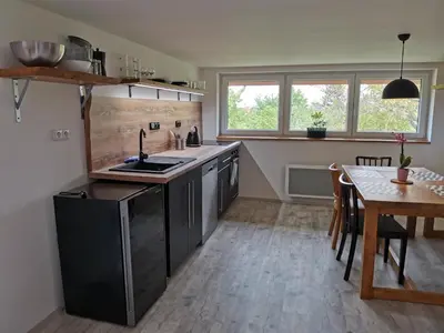 a kitchen with a sink and a table in it at Apartmány Svatá in Svatá