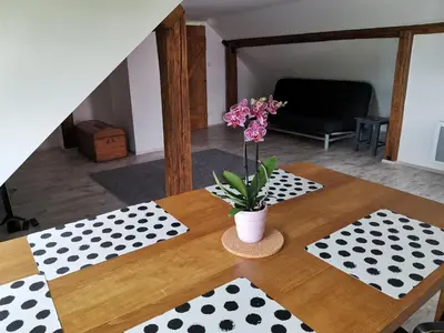 a table with a vase of flowers on top of it at Apartmány Svatá in Svatá