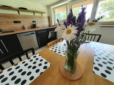 a vase of flowers on a table in a kitchen at Apartmány Svatá in Svatá