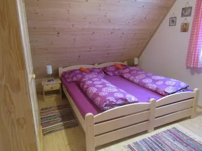 a bed with purple sheets in a room at rekreační dům levandule in Jince