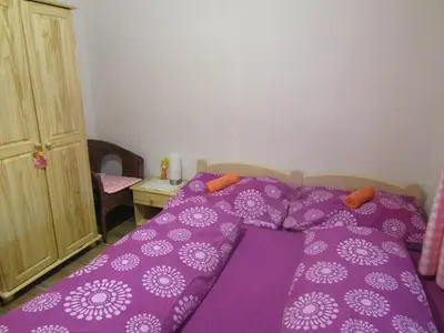a purple bed with a purple comforter in a bedroom at rekreační dům levandule in Jince