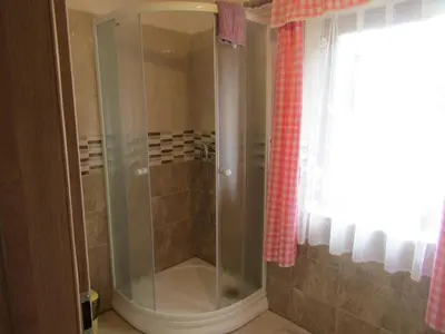 a shower with a glass door in a bathroom at rekreační dům levandule in Jince