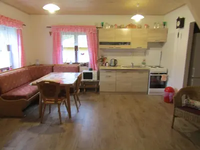 a kitchen and living room with a table and a couch at rekreační dům levandule in Jince