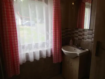 a bathroom with a sink and a window at rekreační dům levandule in Jince