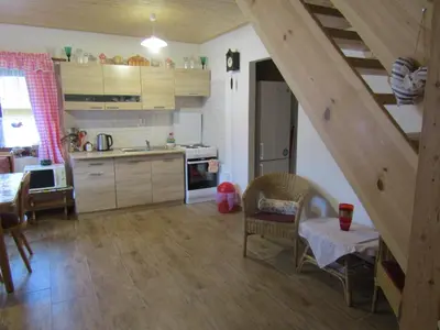 a kitchen with a staircase and a table and chairs at rekreační dům levandule in Jince