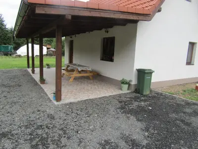 a patio with a picnic table next to a building at rekreační dům levandule in Jince
