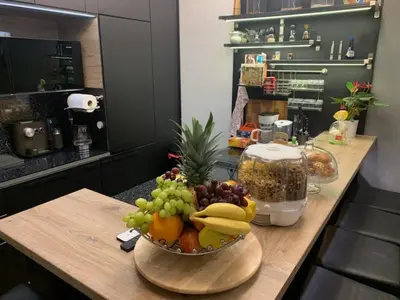 a wooden counter with a bowl of fruit on it at Krejcarek Garden Apartment in Prague