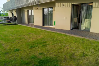 a house with a lawn in front of it at Krejcarek Garden Apartment in Prague