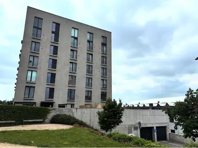 a tall building with people sitting on top of it at Krejcarek Garden Apartment in Prague