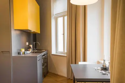 a small kitchen with a table and a window at Design Studio Anděl, All Historical Sights Walkable in Prague