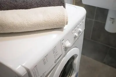 a towel is sitting on top of a washing machine at Design Studio Anděl, All Historical Sights Walkable in Prague