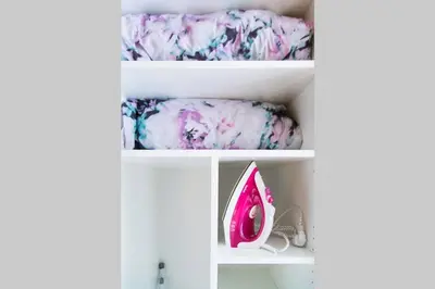 a white shelf with pink and purple sheets at Design Studio Anděl, All Historical Sights Walkable in Prague