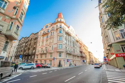 a large building on a city street with cars parked at Design Studio Anděl, All Historical Sights Walkable in Prague