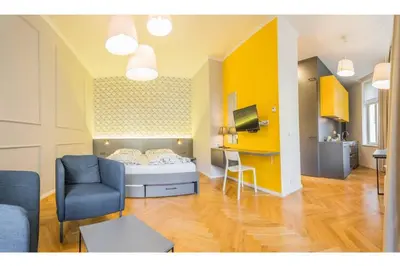a room with a bed and a couch and a chair at Design Studio Anděl, All Historical Sights Walkable in Prague