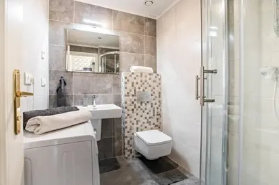 a bathroom with a toilet and a sink and a shower at Design Studio Anděl, All Historical Sights Walkable in Prague