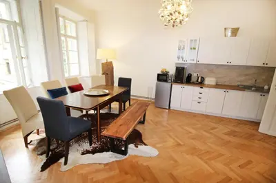 a kitchen and dining room with a table and chairs at Fano Apartments Old Town Prague in Prague