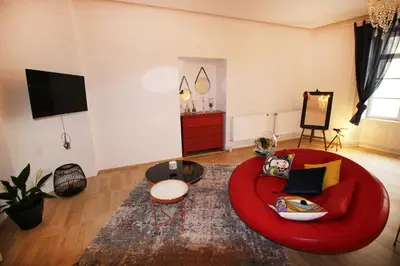 a living room with a red couch and a table at Fano Apartments Old Town Prague in Prague