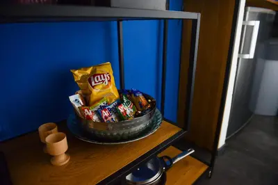 a shelf with a basket of candy and snacks at Fano Apartments Old Town Prague in Prague