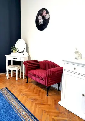 a living room with a red couch and a table at MIRON Apartman 1 in Prague