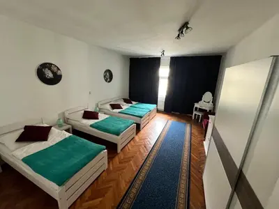 a room with two beds and a table in it at MIRON Apartman 1 in Prague