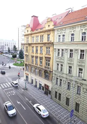a city street with cars parked in front of buildings at MIRON Apartman 1 in Prague