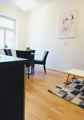 a living room with a table and chairs at MIRON Apartman 1 in Prague