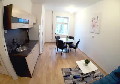 a kitchen and living room with a table and chairs at MIRON Apartman 1 in Prague