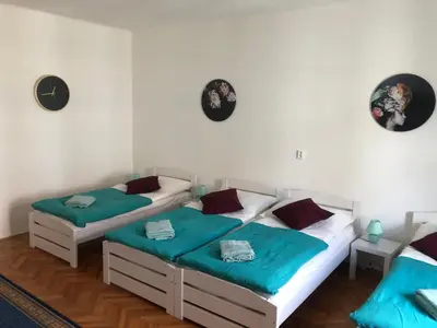 two twin beds in a room with white walls at MIRON Apartman 1 in Prague