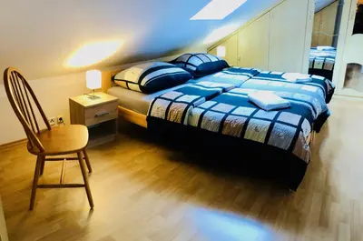 a bedroom with a bed and a chair and a table at Penzion Laterna in Litoměřice