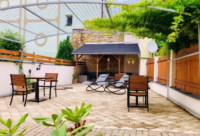 a patio with chairs and a table and a pavilion at Penzion Laterna in Litoměřice