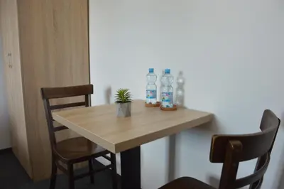 a table with two bottles of water and two chairs at Pension 1310 in Mladá Boleslav