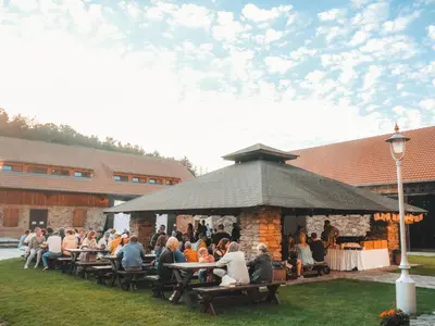 a group of people sitting at tables in a pavilion at Mlýn Davídkov in Hryzely