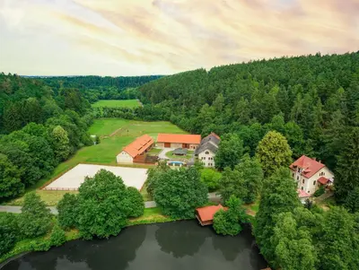 an aerial view of a house on an island in the water at Mlýn Davídkov in Hryzely