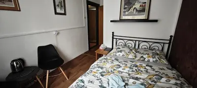 a bedroom with a bed and a desk and a chair at Orbis in Prague