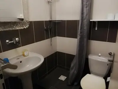 a small bathroom with a toilet and a sink at Orbis in Prague