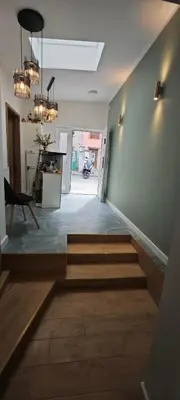 a hallway with stairs and a table and chandeliers at Orbis in Prague