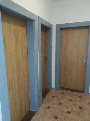 an empty room with two doors and a tile floor at Orbis in Prague