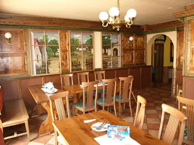 a dining room with wooden tables and chairs at Hotel U Lípy in Krušovice