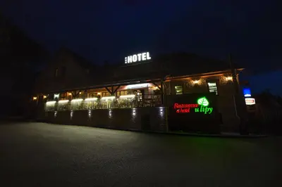 a restaurant at night with lights on it at Hotel U Lípy in Krušovice